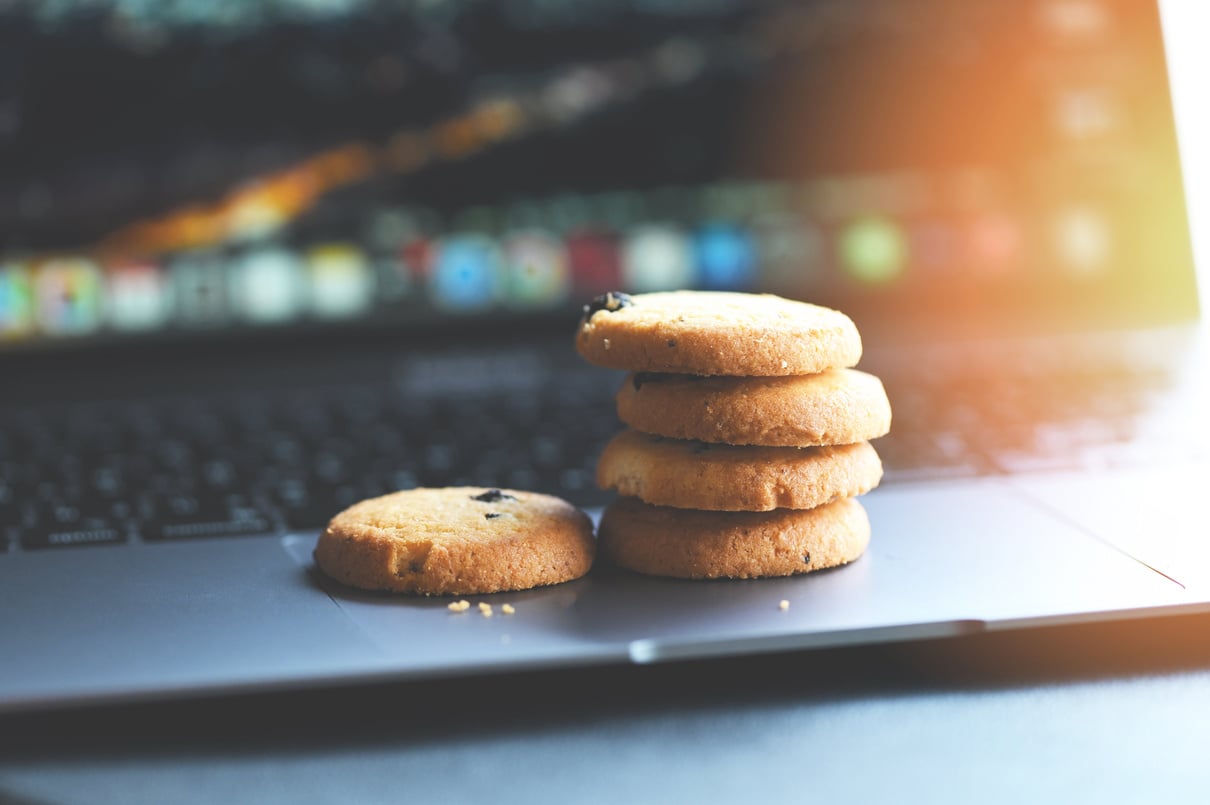 a depiction of third-party, cookies stack of cookies sitting on top of a laptop 