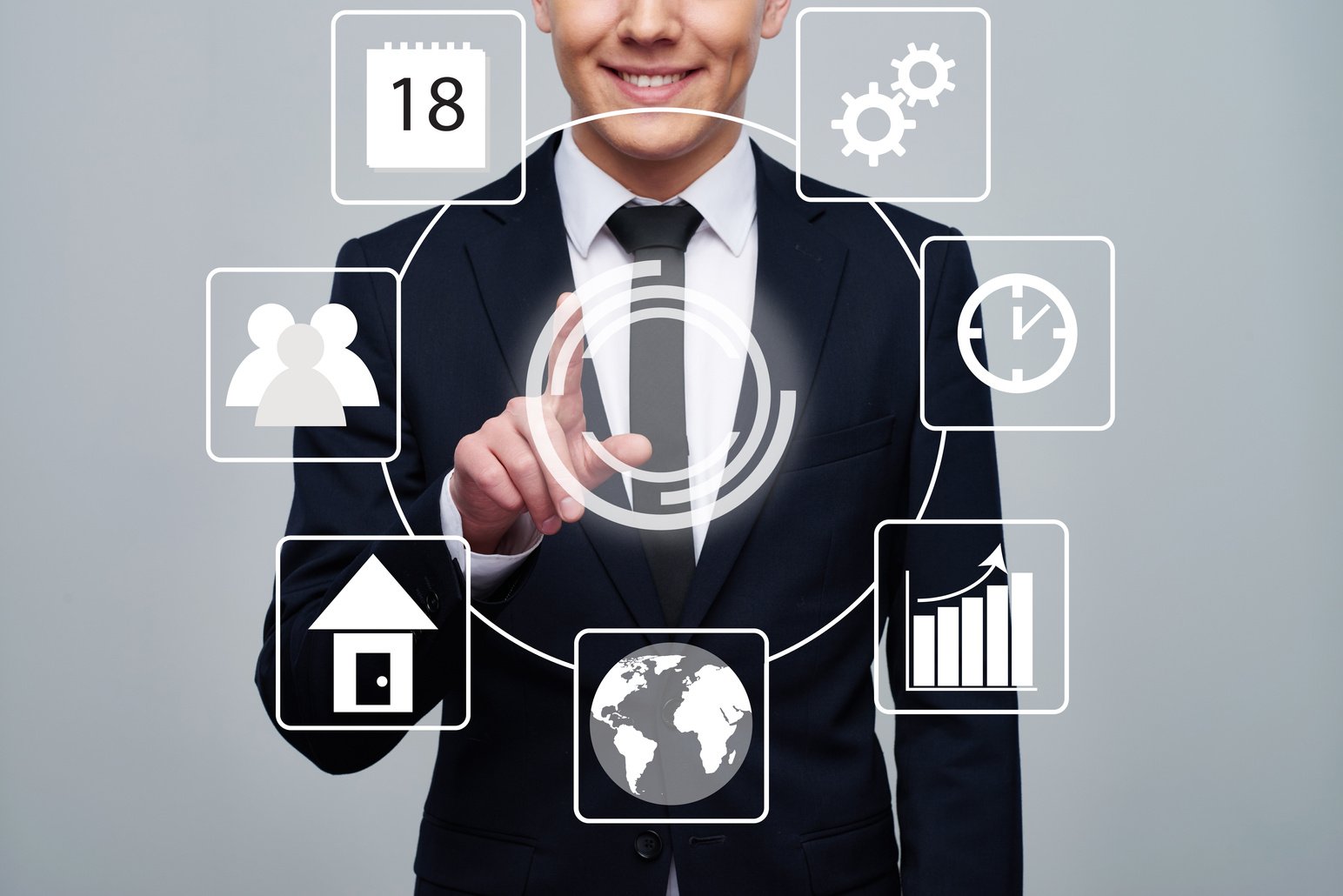 A business person in a suit touching an AI button with icons around it.